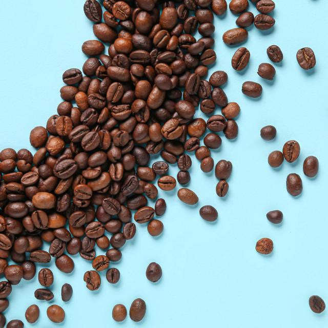 Black Coffee Roasters kaffebønner på blåt bord